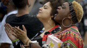 People listen to a speaker at a Juneteenth rally in Tulsa, Okla., Friday, June 19, 2020. Juneteenth marks the day in 1865 when federal troops arrived in Galveston, Texas, to take control of the state and ensure all enslaved people be freed, more than two years after the Emancipation Proclamation. 