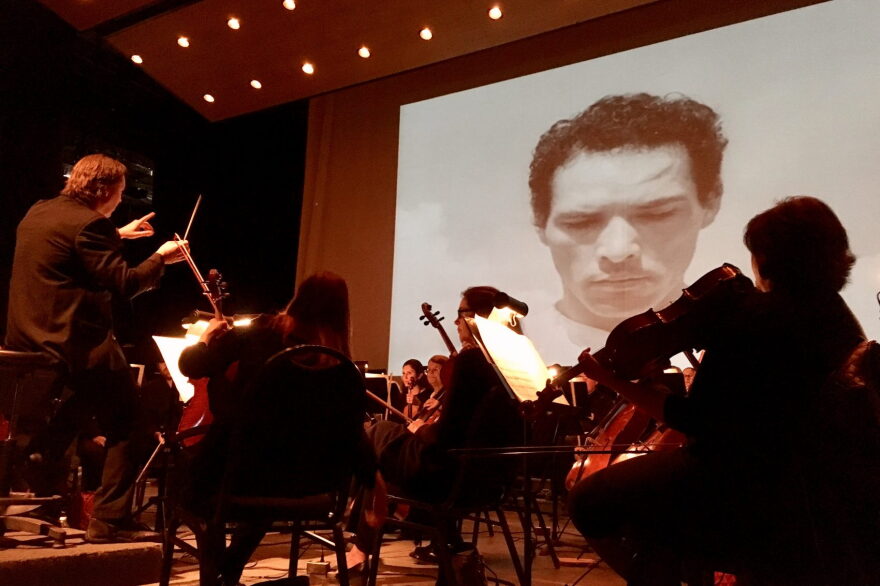 A screening of the iconic Mexican film "Redes" at the Music Unwound festival, accompanied by the El Paso Symphony Orchestra, which performed the score live. (Armando Trull/WAMU)
