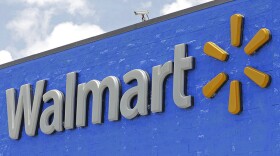 FILE - A Walmart sign displayed on the facade of a store in Hialeah Gardens, Fla., on June 1, 2017. Walmart is adding four new fulfillment centers to its existing capacity, a move that will bring more than 4,000 jobs and make next- or two-day shipping available to more Americans.