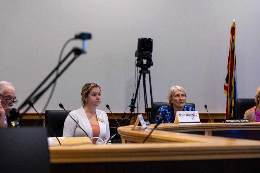 Two women sit in a room.