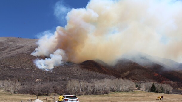 Fire managers observe as the smoke from the Sunnyside prescribed fire blows east towards Hunter Creek, near Aspen, CO.