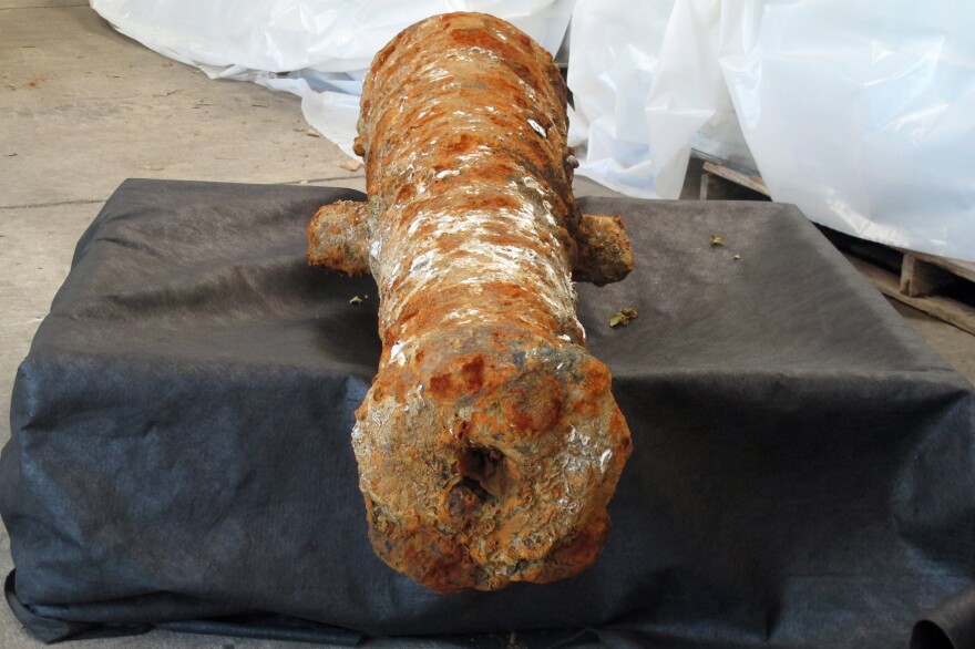 A cannon encrusted in rust and mud sits inside a warehouse operated by the Army Corps of Engineers in Savannah, Ga., on Thursday. It's one of 19 cannons discovered in the Savannah River since last year that experts believe date to the American Revolution.