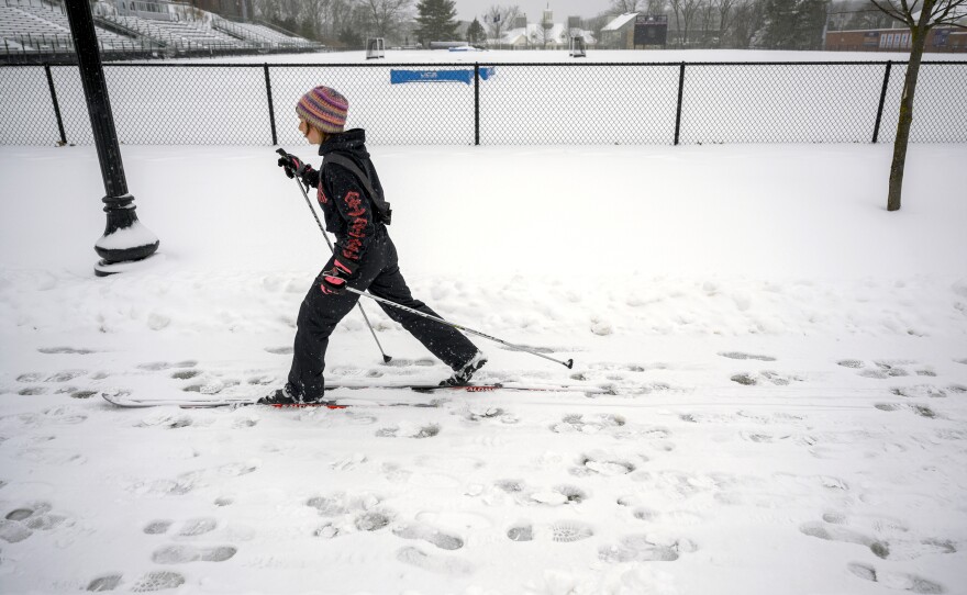 UConn student Amelia Colombo skis her way back from breakfast through the morning’s fresh snow. Colombo said the walk to her dining hall usually takes only 15 minutes, but with the snow and her skis, she added “some loops” to the trip to extend it to an hour.