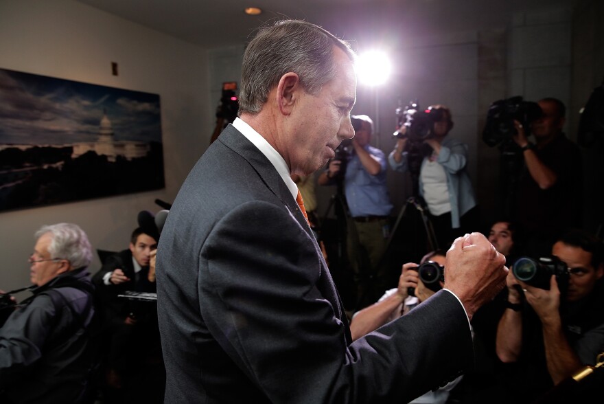 Speaker of the House John Boehner pumps his fist after leaving a meeting of House Republicans at the U.S. Capitol on Wednesday.