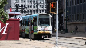 The NFTA light rail metro line stopped at a station outside the Seneca One Tower.
