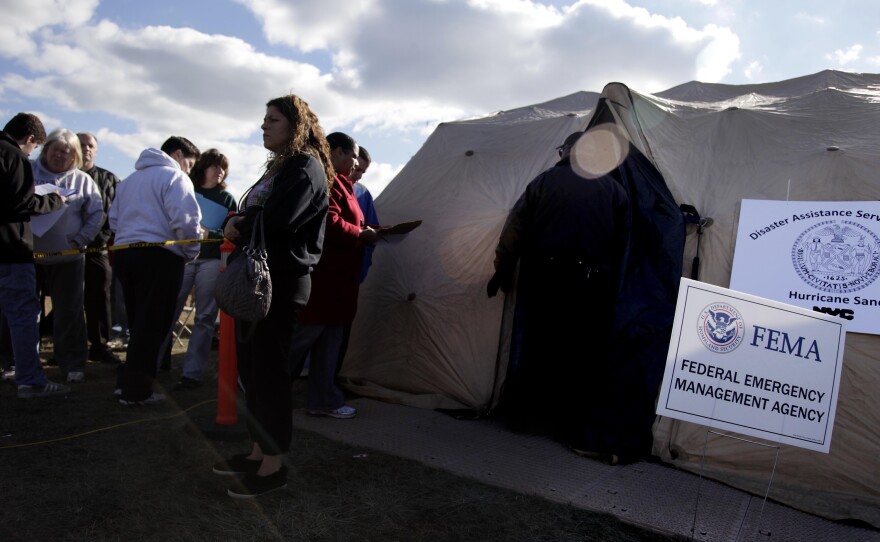 Residents affected by Superstorm Sandy wait outside a FEMA tent in 2012. FEMA has made disaster legal services available after past disasters, including Sandy and hurricanes Harvey, Irma and Maria.