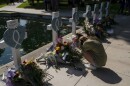 Elena Mendoza, 18, grieves in front of a cross honoring her cousin, Amerie Jo Garza, one of the victims killed in this week's elementary school shooting in Uvalde, Texas, Thursday, May 26, 2022.