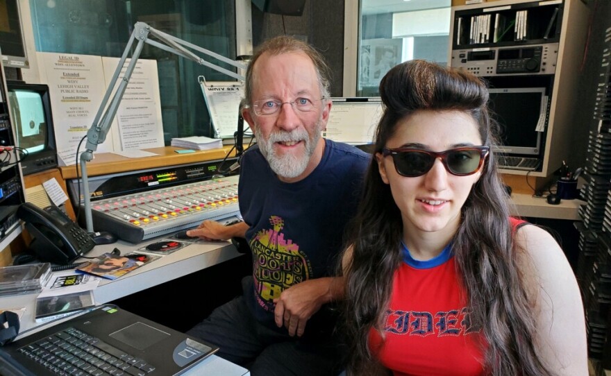 Carlos Benjamin and Veronica Lewis sit in the WDIY on-air studio behind the on-air board.