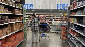 A shopper fills up a cart at a grocery store on Dec. 21.