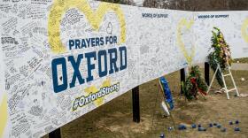 Handwritten messages are left at the memorial site outside Oxford High School in Oxford, Mich.