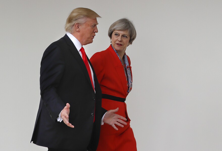 President Trump and British Prime Minister Theresa May walk along the colonnades of the White House in Washington, D.C., on Friday.