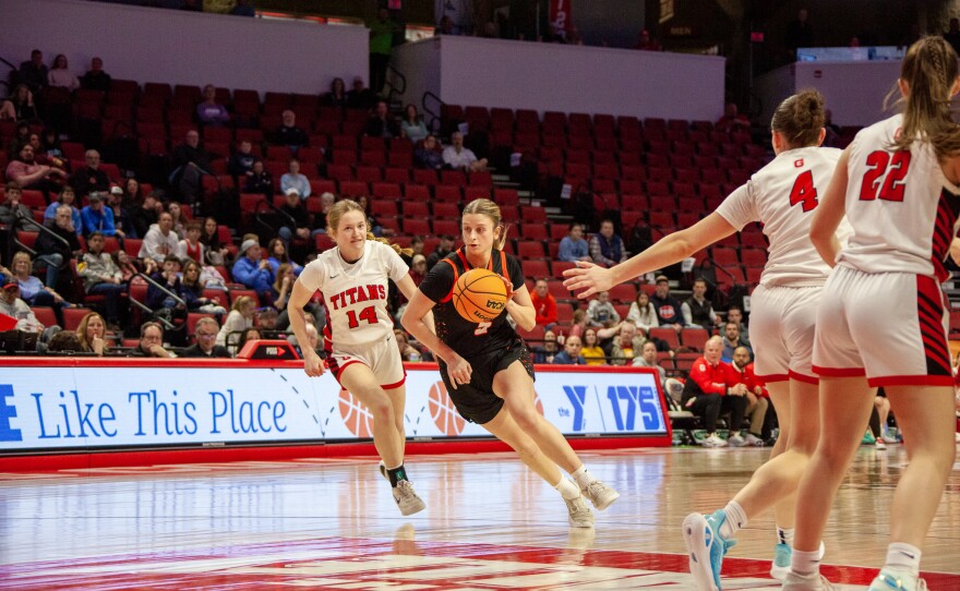Girls high school basketball players inside an arena