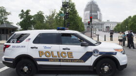 A police car drives past the US Capitol and the Capitol Visitor Center after the building was evacuated due to reports of a fire in Washington, DC.