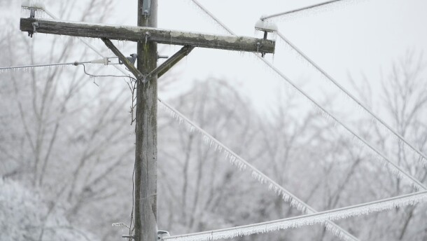 Ice covers lines on a utility pole during a winter storm Sunday, Jan. 25, 2026, in Nashville, Tenn.