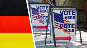 Voting signs next to a German flag.