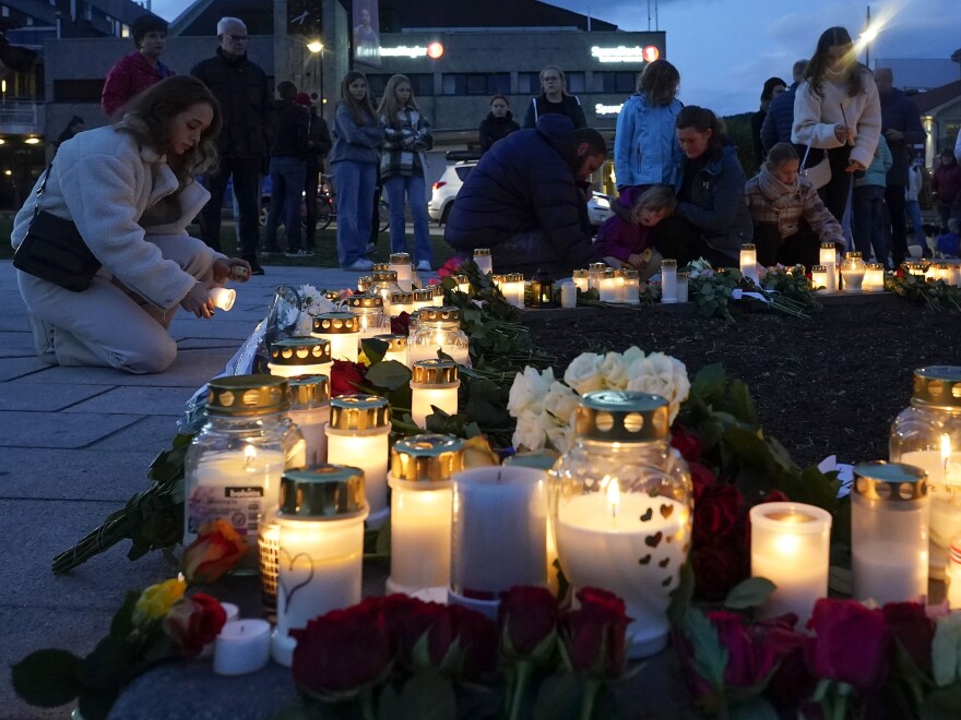 Flowers and candles are placed at the scene of an attack on the square, in Kongsberg, Norway, Thursday. Norwegian authorities say the bow-and-arrow rampage by a man who killed five people in a small town appeared to be a terrorist act. Police identified the attacker as Espen Andersen Braathen, a 37-year-old Danish citizen, who was arrested Wednesday night.