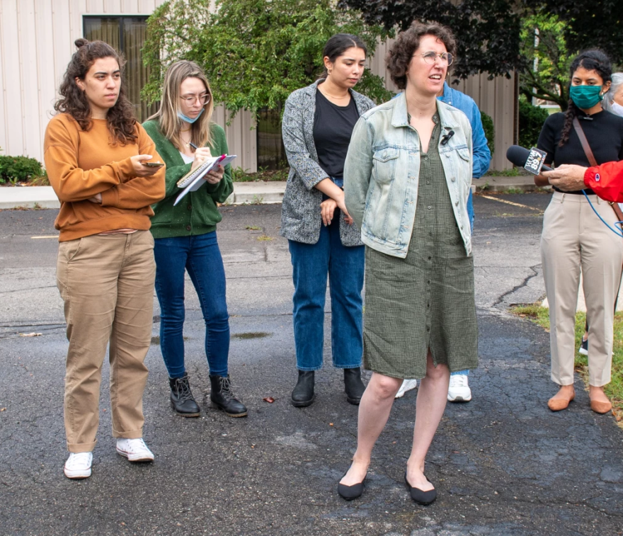 Hilary Lewis of Industrious Labs (foreground) speaks to news reporters during a tour of Detroit-area steel and car-making plants.