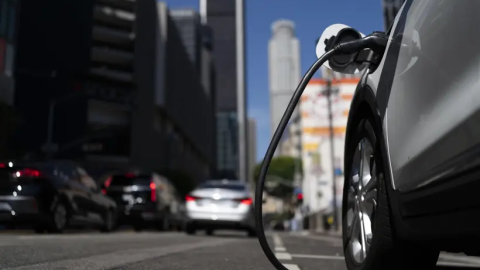 An electric vehicle is plugged into a charging station in California.