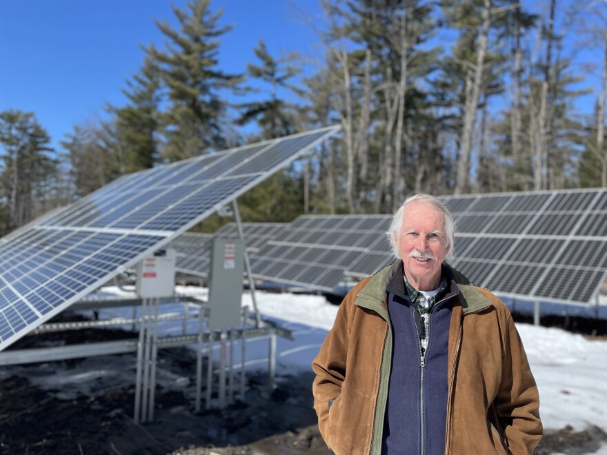 Carl Martland stands next to Sugar Hill's solar array