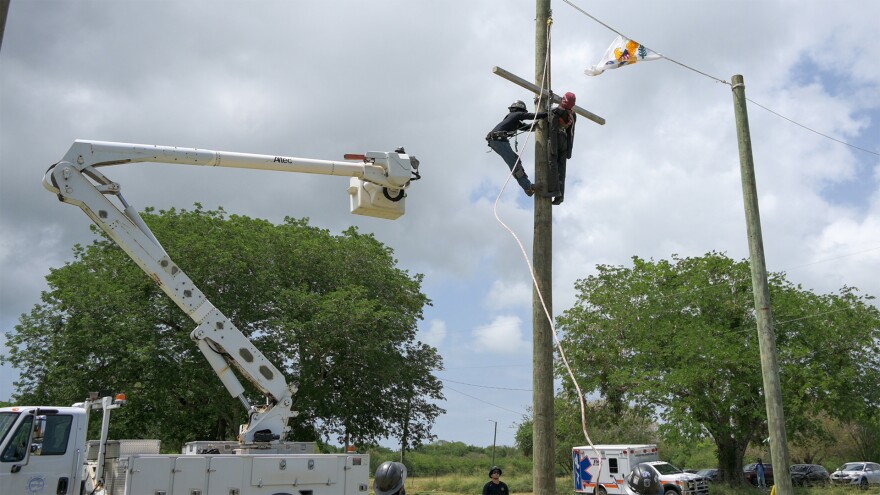 Pictured: WAPA lineworkers demonstrate climbing and utility restoration techniques during the Authority’s first Lineworker Exhibition and Festival at the Agricultural Fairgrounds on St. Croix.
