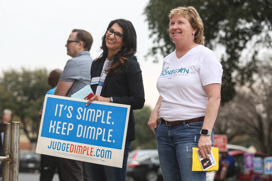 Judge Dimple Malhotra greets voters on Election Day in March with then-candidate for Travis County sheriff, Liz Donegan.