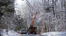 In this file photo, an electric company crew works to restore power to customers in Downingtown, Pennsylvania.