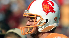 Former player Connor Barth wears a Buccaneers' helmet with the original "Bucco Bruce" logo before the 2011 "throwback" game. For the first time since 2012, the team will again where "throwback" Creamsicle orange.