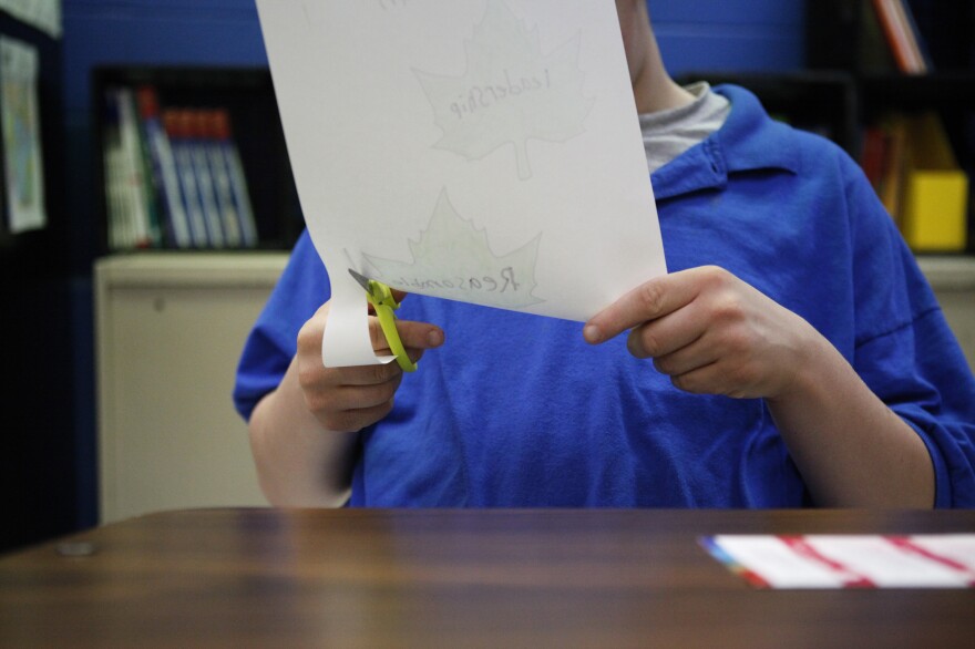 A student cuts out leaves in Lisa Elder's Life Skills class.