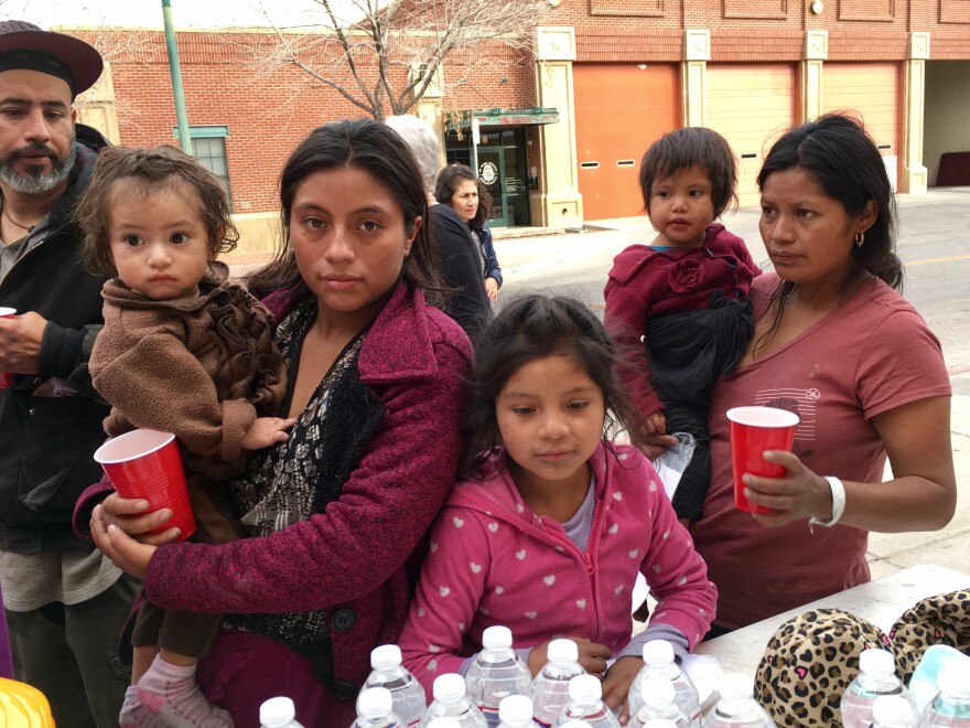 Two Guatemalan mothers released from federal custody get water at a volunteer station in downtown El Paso on Christmas Day.