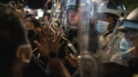 Police hold off protesters during a solidarity rally for George Floyd, Sunday, May 31, 2020, in Brooklyn, New York. (Wong Maye-E/AP)