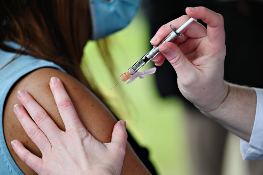 A Hartford HealthCare worker administers a COVID-19 vaccine