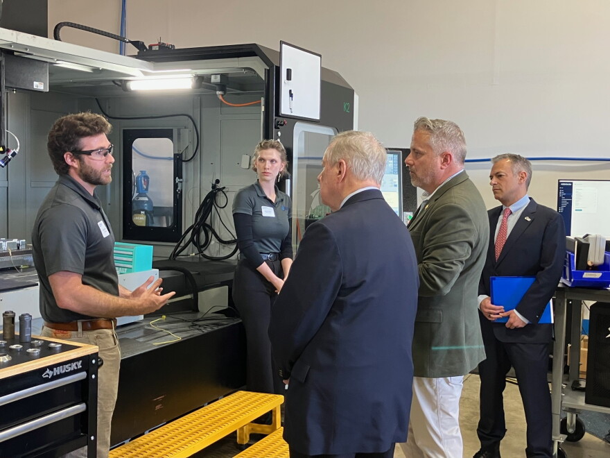ASTRO America employees explain their jobs to U.S. Sen. Dick Durbin and U.S. Rep. Eric Sorensen during a tour of the company's Moline facility, Thursday, Oct. 29, 2026.
