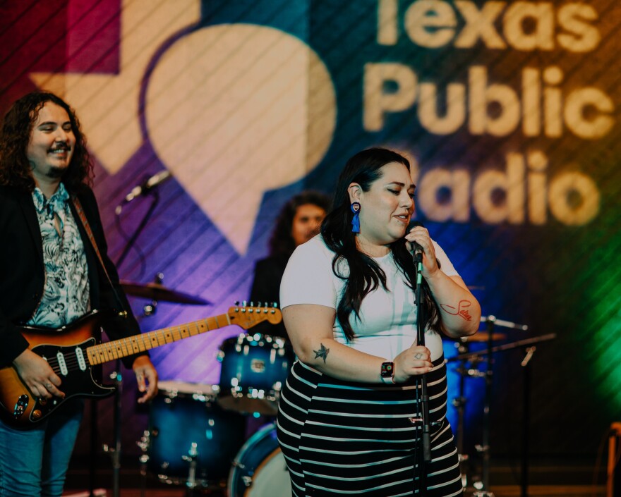 Stephanie Bergara displays her "Selena" tattoo while singing with Bidi Bidi Banda.