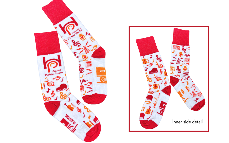 A pair of cotton blend, crew-length socks that celebrates both HPR-1 and HPR-2 with red, orange and yellow radio and music-themed designs on a white backing