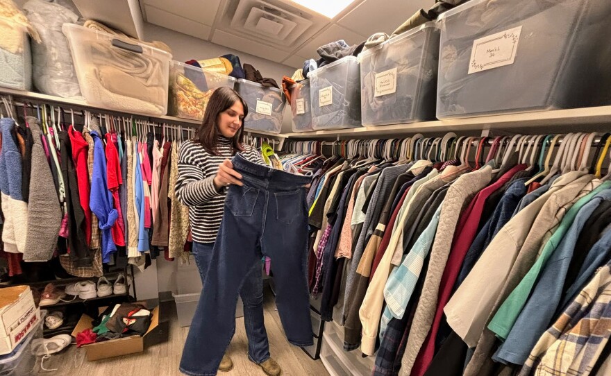 Jac Carroll, manager of Waypoint's shelter and supportive services in Manchester, helps organize a closet of donated clothes available to youth who use it's drop-in center and shelter in Manchester.
