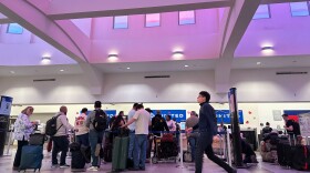 People stand in line at check-in counters at El Paso International Airport, Wednesday, Feb. 11, 2026, in El Paso, Texas.