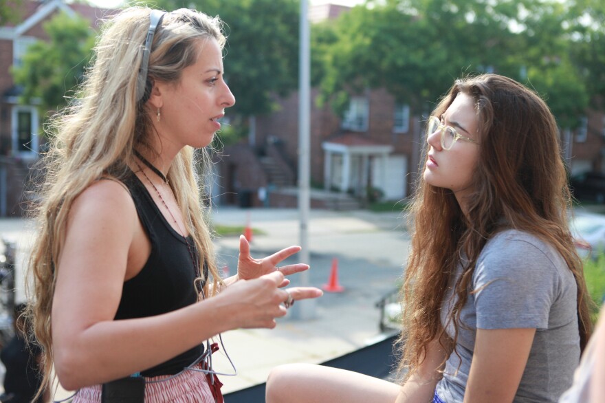 Director Crystal Moselle (left) speaks with Rachelle Vinberg on the set of <em>Skate Kitchen</em>.