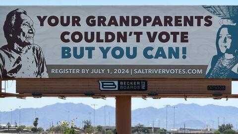 A billboard along East McDowell Road urges Salt River Pima-Maricopa Indian Community members to register to vote in 2024.