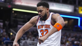 New York Knicks center Karl-Anthony Towns (32) reacts after hitting a basket and being fouled against the Indiana Pacers during the first half of an NBA basketball game in Indianapolis, Tuesday, Feb. 11, 2025. (AP Photo/Michael Conroy)