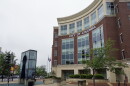 The exterior of Columbia's Daniel Boone City Building is shot from the East across Eighth Street. There is a tree in the bottom right third. It is overcast in the afternoon. 