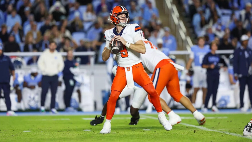 Syracuse quarterback Steve Angeli (9, White) holds a football and looks for a target against UNC on Saturday.