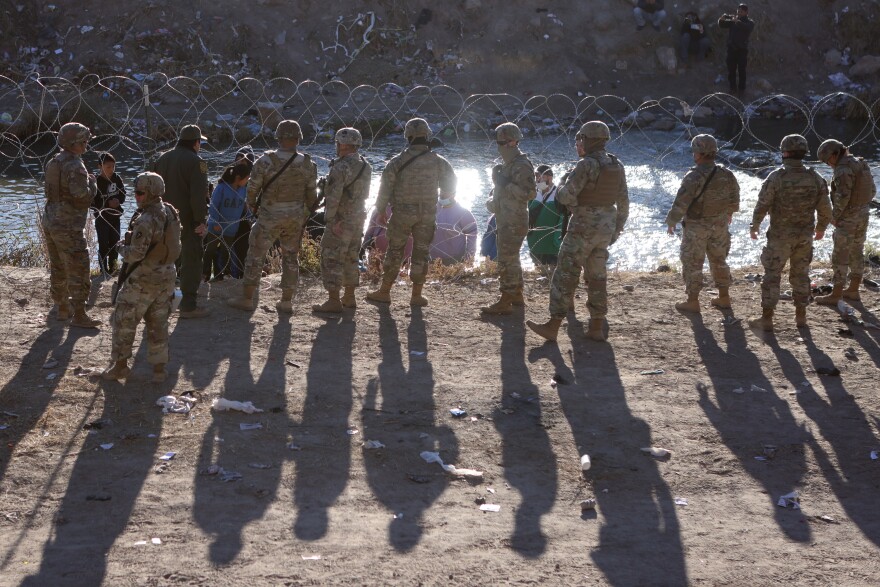 Members of the Texas National Guard stop asylum-seeking migrants attempting to cross the border into the United States in El Paso, Texas, U.S., December 21, 2022.