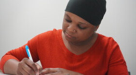 Elsie Alex-Tanner, crisis intervention specialist at Marion Senior Services, writing on her notepad. (Rachel Hunter/WUFT News)