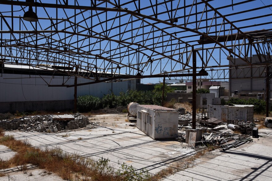 Faysal Shawa's warehouse was damaged in the 2014 conflict. Shawa and employees maintain no connection to Hamas.