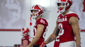 Indiana wide receivers Charlie Becker (left) and Nick Marsh walk the field during the first day of spring football practice Thursday.