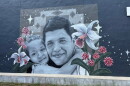 A mural of Johan Sebastian Guererro and his daughter on a building in Biddeford.