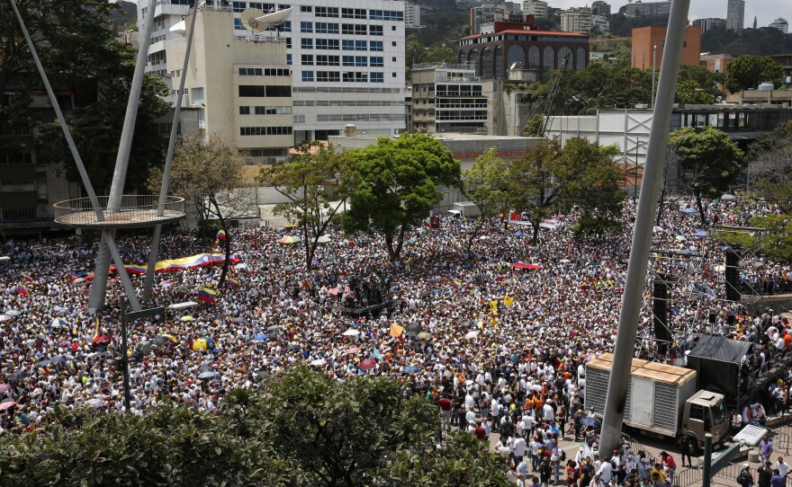 Anti-government protesters rally to demand the resignation of Venezuelan President Nicolas Maduro in Caracas on Monday, the same day opposition leader Juan Guaidó returned to the country.