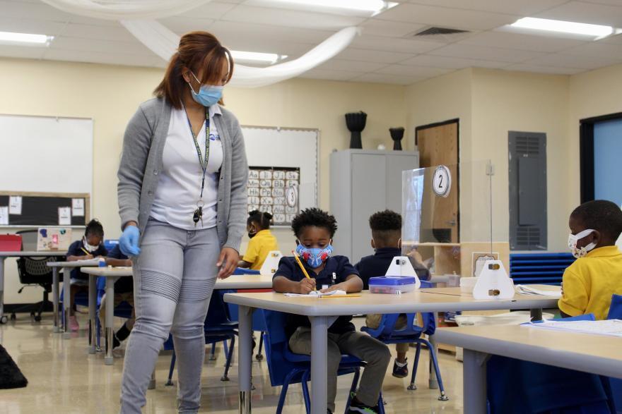 A teacher works on a writing exercise with PreK students at KIPP Central City Primary. Oct. 2, 2020.