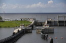FILE: In this Friday, Oct. 25, 2019, 2019 photo, the doors of a lock open at Port Mayocca, Fla., allowing a sailboat to enter he St. Lucie Canal after leaving Lake Okeechobee, background. The lock and dam was built in 1977 to raise the water level in the lake and provide flood control.