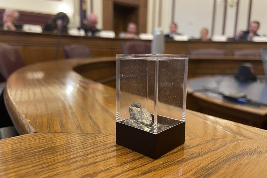 A container with 10 grams of yttrium, a rare earth element, is passed around during a meeting of the Indiana Rare Earth Recovery Council on Nov. 13, 2025.